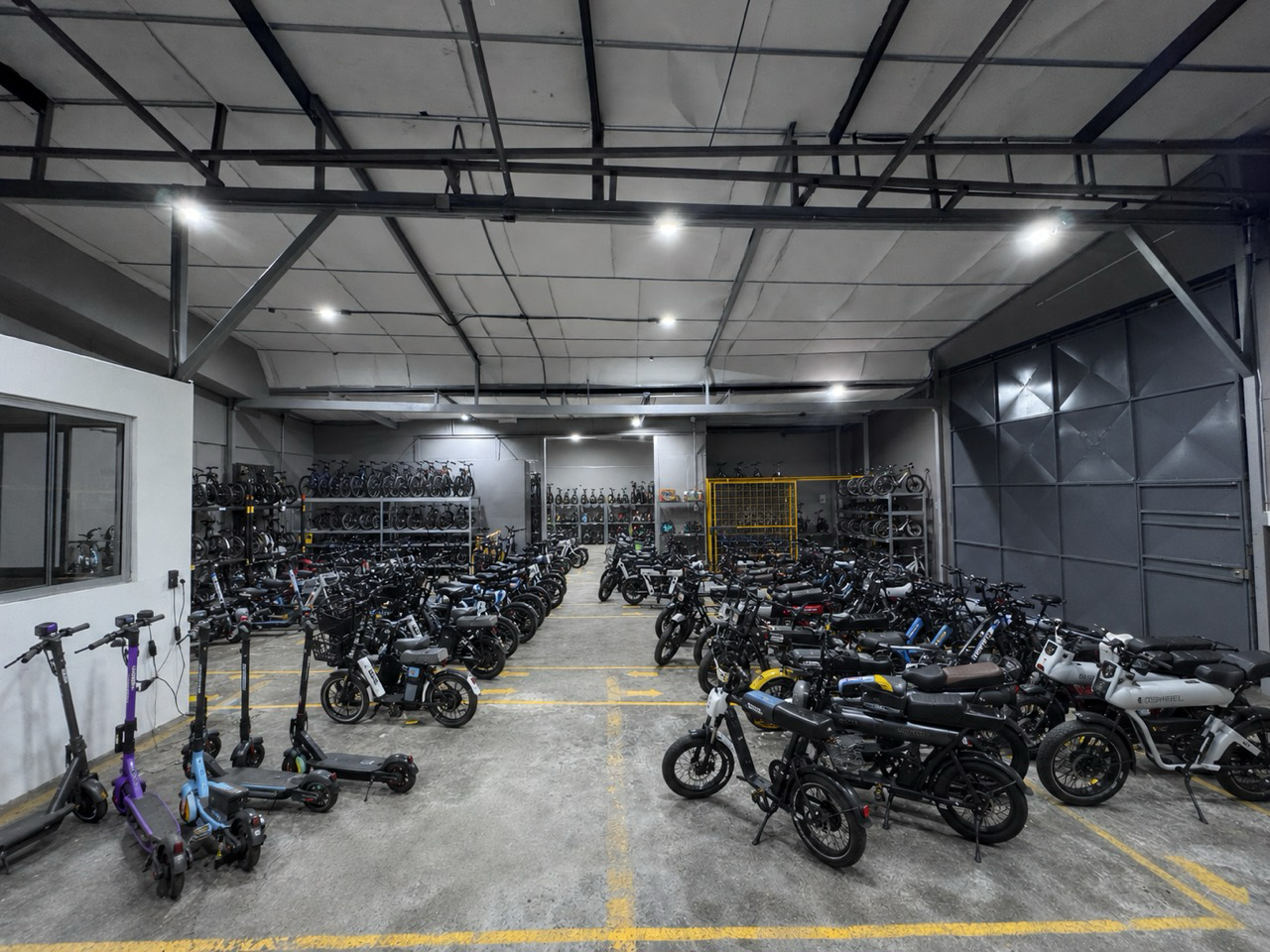 AI-generated visualization of organized motorcycle, e-bike, and scooter inventory inside a warehouse